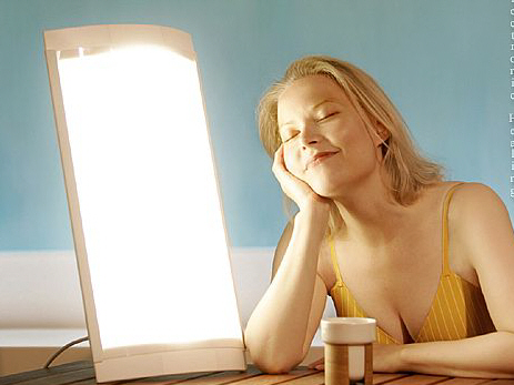 Woman next to light device