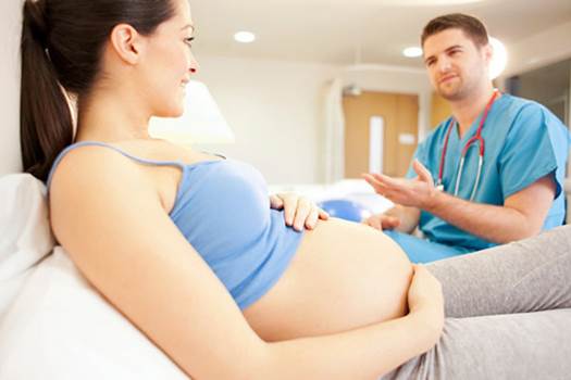 Pregnant woman with doctor