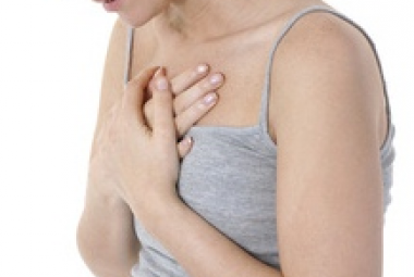 Pregnant woman holding chest
