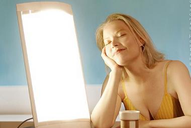 Woman next to light device